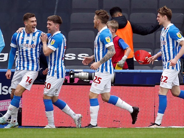 Huddersfield Town's Josh Ruffels celebrates scoring their first goal with teammates on April 1, 2023