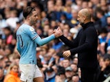 Manchester City's Jack Grealish shakes hands with manager Pep Guardiola after being substituted on April 1, 2023