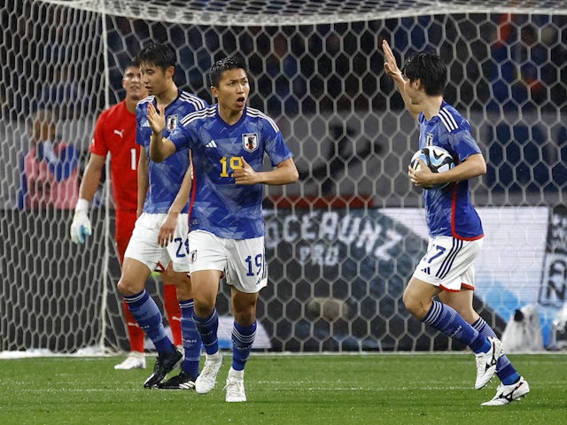 Japan's Takuma Nishimura celebrates with teammates after scoring their first goal on March 24, 2023