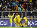 Kazakhstan's Askhat Tagybergen celebrates scoring their second goal with teammates on March 26, 2023