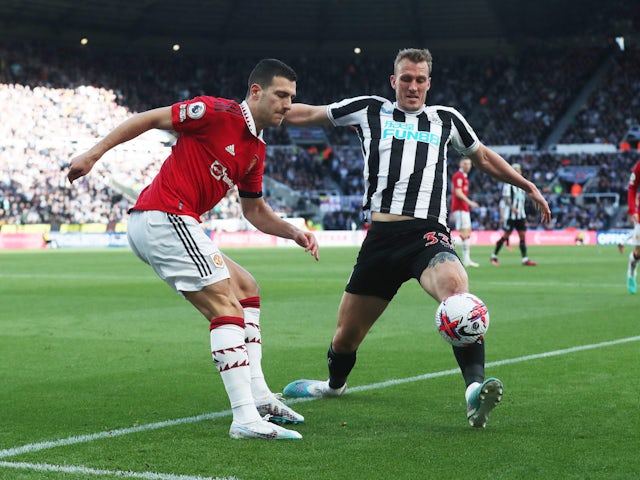 Newcastle United's Dan Byrne in a match with Manchester United's Diogo Dalot on April 2, 2023.