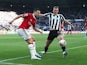 Newcastle United's Dan Burn in action with Manchester United's Diogo Dalot on April 2, 2023