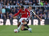 Newcastle United's Dan Burn in action with Manchester United's Marcus Rashford on April 2, 2023