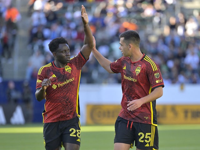 Seattle Sounders defender Yeimar Gomez (28) and Seattle Sounders defender Jackson Ragen (25) high five after a goal on April 2, 2023