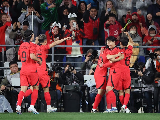 South Korea's Son Heung-min celebrates with teammates after scoring their first goal on March 24, 2023