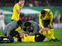 Borussia Dortmund's Mats Hummels receives medical attention after sustaining an injury on April 5, 2023