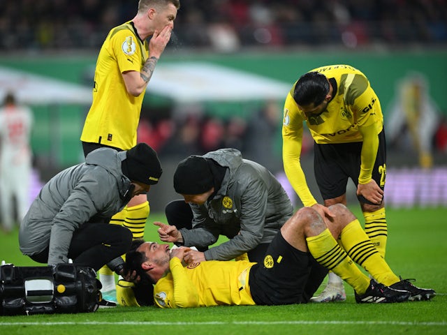 Borussia Dortmund's Mats Hummels receives medical attention after sustaining an injury on April 5, 2023
