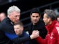West Ham United manager David Moyes shakes hands with assistant coach Albert Stuivenberg before the match as Arsenal manager Mikel Arteta looks on on May 1, 2022
