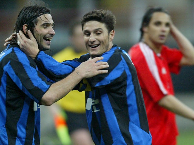 Inter Milan's Daniele Adani (L) and his team mate Javier Zanetti celebrate at the end of the UEFA Cup fourth round, second leg match against Benfica in April 2004