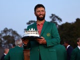 Spain's Jon Rahm celebrates with his green jacket and the trophy after winning The Masters on April 9, 2023