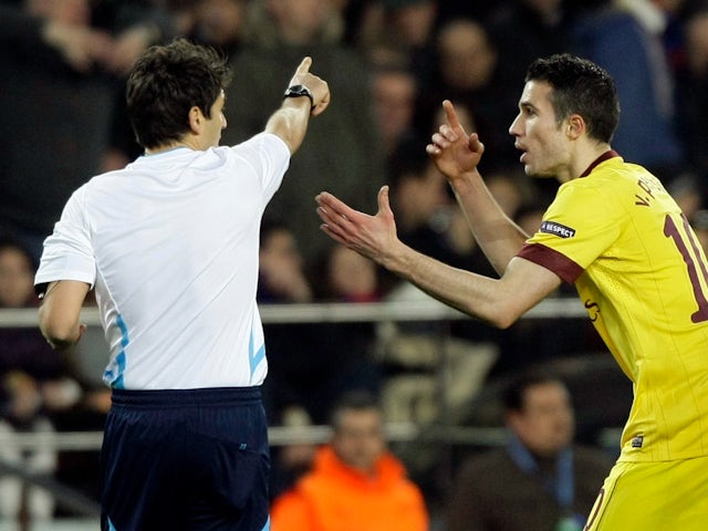 Arsenal striker Robin van Persie remonstrates with referee Massimo Busacca in 2011