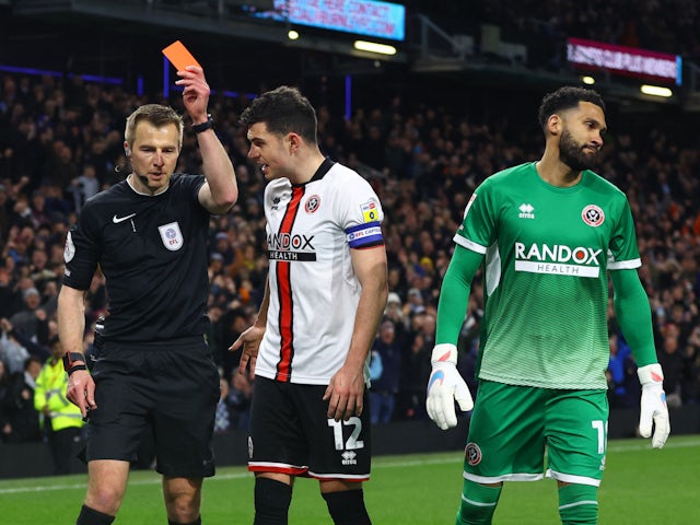 Sheffield United's Wes Foderingham is shown a red card by referee Michael Salisbury on April 10, 2023