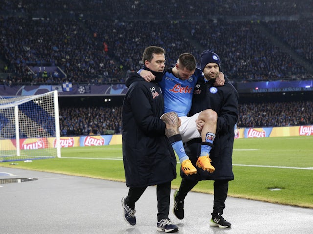 Napoli's Matteo Politano is carried off the pitch after sustaining an injury on April 18, 2023