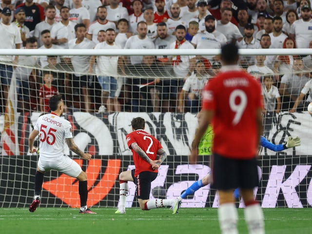 Sevilla's Lucas Ocampos scores before it is disallowed after a VAR review against Manchester United on April 20, 2023