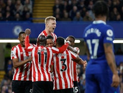 Brentford's Ben Mee celebrates with teammates after their first goal scored by Chelsea's Cesar Azpilicueta with an own goal on April 26, 2023
