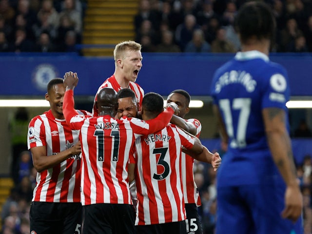 Brentford's Ben Mee celebrates with teammates after their first goal scored by Chelsea's Cesar Azpilicueta with an own goal on April 26, 2023