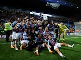 Burnley players celebrate on the pitch after winning the match to become champions on April 25, 2023