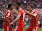 Bayern Munich's Serge Gnabry celebrates scoring their first goal with Thomas Mueller and Noussair Mazraoui on April 30, 2023