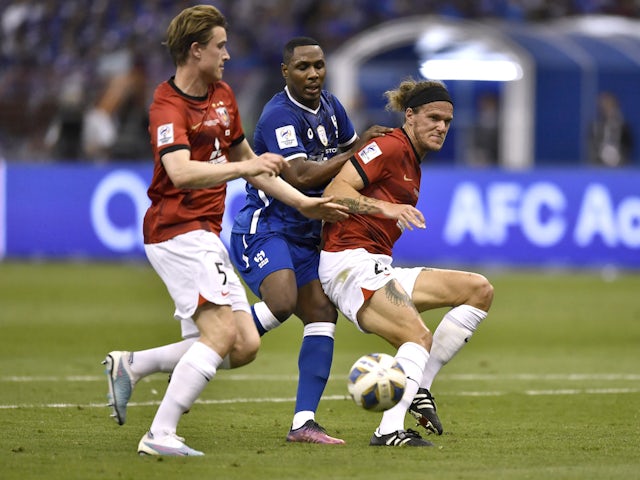 Al-Hilal's Odion Ighalo in action with Urawa Red Diamonds' Alexander Scholz and Marius Hoibraaten on April 29, 2023