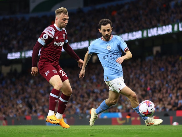 Manchester City's Bernardo Silva in action with West Ham United's Jarrod Bowen on May 3, 2023
