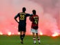 Inter Milan's Marco Materazzi and AC Milan's Rui Costa look on as supporters throw flares onto the pitch during their Champions League quarter-final second leg on April 12, 2005