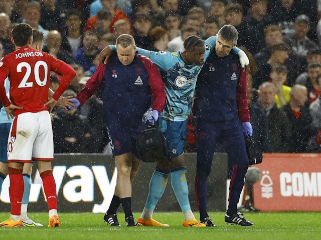 Southampton's Armel Bella-Kotchap is helped off the pitch after sustaining an injury on May 8, 2023