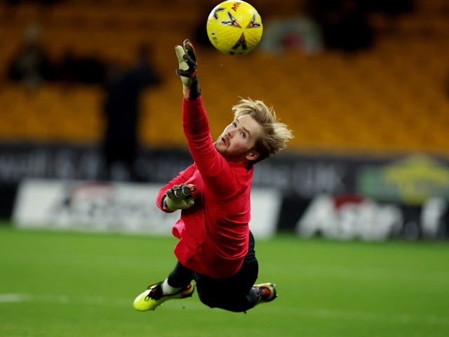 Liverpool goalkeeper Caoimhin Kelleher warms up in January 2023