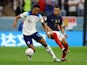 England's Jude Bellingham in action with France's Kylian Mbappe on December 10, 2022