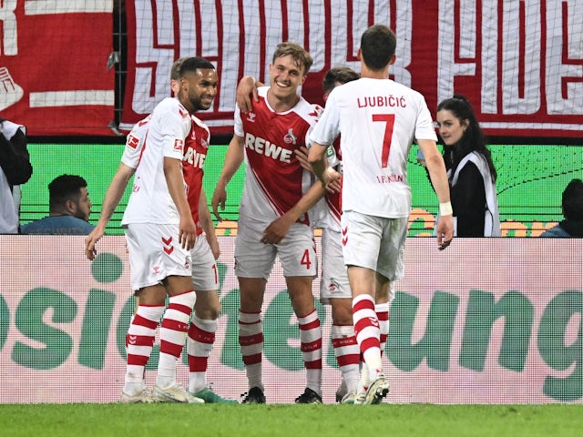 Koln's Timo Hubers celebrates scoring their fourth goal with teammates on May 12, 2023
