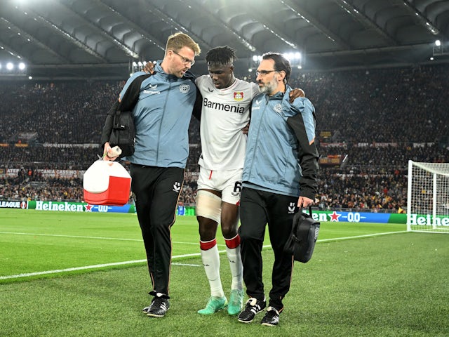 Bayer Leverkusen's Odilon Kossounou receives medical attention after sustaining an injury on May 11, 2023