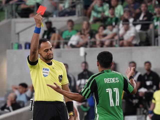 Austin FC forward Rodney Redes (11) receives a red card during the second half on May 14, 2023
