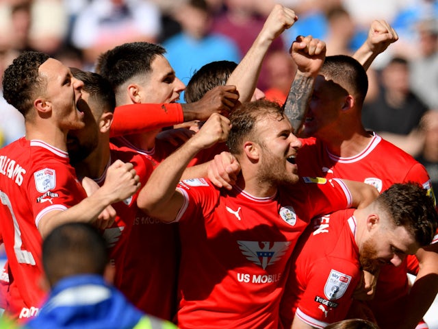 Barnsley's Nicky Cadden celebrates scoring their first goal with teammates on May 13, 2023