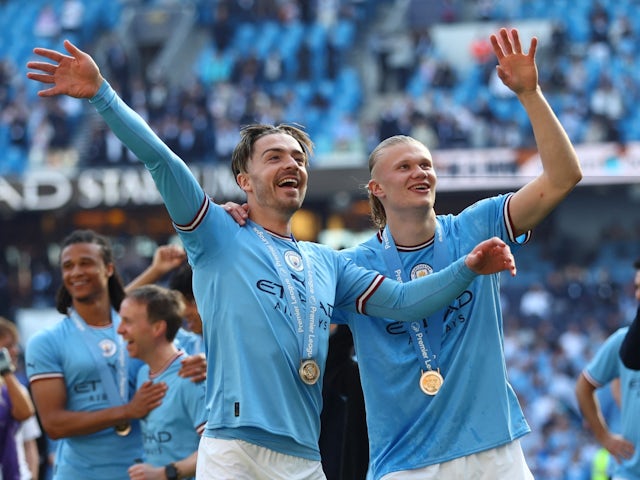 Manchester City's Jack Grealish and Erling Braut Haaland celebrate after winning the Premier League on May 21, 2023