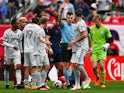 St Louis City SC defender John Nelson (14) is given a red card by referee Filip Dujic after receiving his second yellow card on May 13, 2023