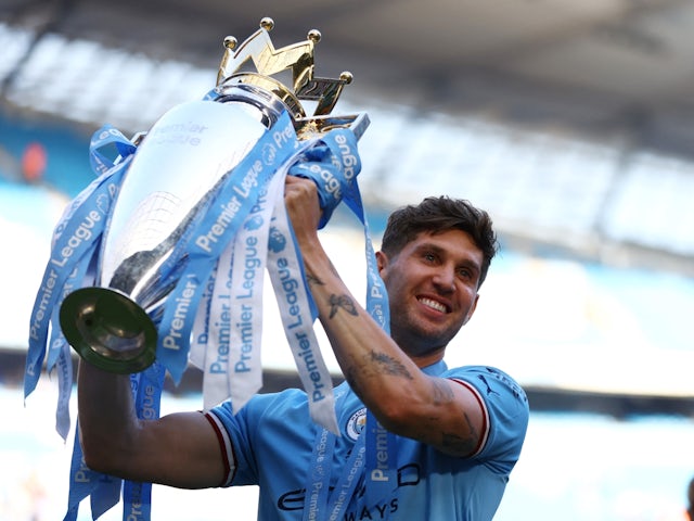 Manchester City's John Stones celebrates with the trophy after winning the Premier League on May 21, 2023