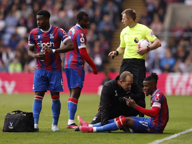 Crystal Palace's Wilfried Zaha receives medical attention on May 13, 2023