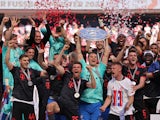 Bayern Munich's Manuel Neuer celebrates with the trophy and teammates after winning the Bundesliga on May 27, 2023