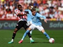Brentford's Frank Onyeka in action with Manchester City's Cole Palmer on May 28, 2023