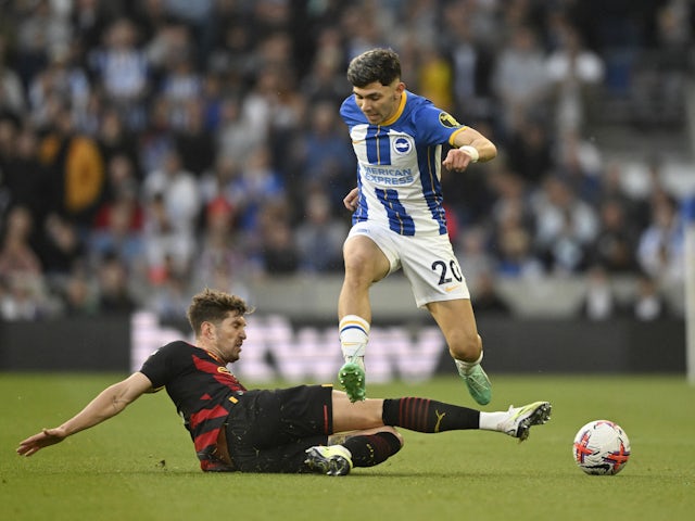 Brighton & Hove Albion's Julio Enciso in action with Manchester City's John Stones on May 24, 2023