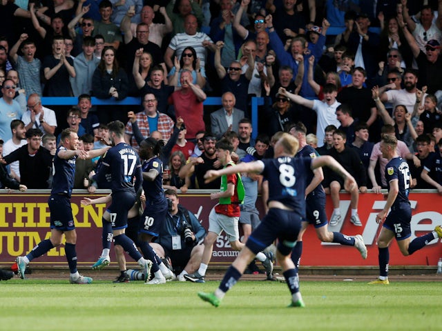 Carlisle United's Ben Barclay celebrates scoring their third goal with teammates on May 20, 2023