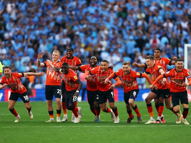Luton Town players celebrate earning promotion to the Premier League on May 27, 2023