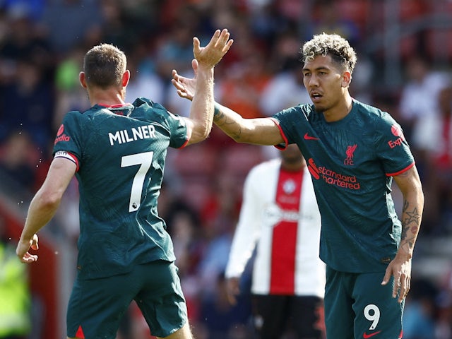 Liverpool's Roberto Firmino celebrates scoring their second goal with James Milner on May 28, 2023