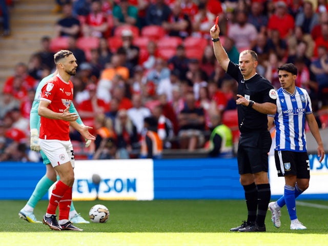 Barnsley's Adam Phillips is shown a red card by referee Tim Robinson on May 29, 2023