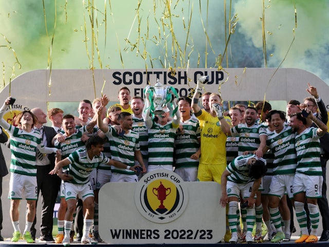 Celtic's Callum McGregor celebrates with the trophy and teammates after winning the Scottish Cup on June 3, 2023