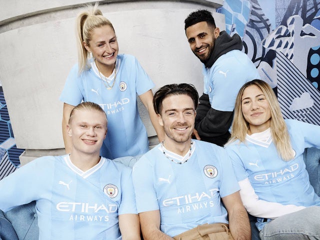 Erling Braut Haaland and Jack Grealish in Man City's 2023-24 home kit