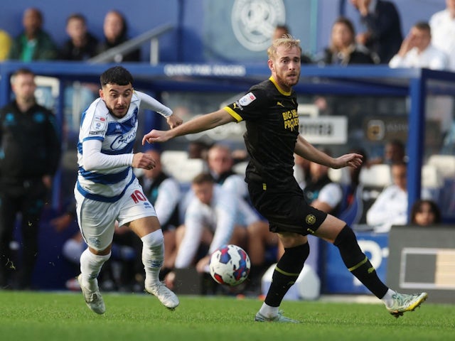 Queens Park Rangers' Ilias Chair in action with Wigan Athletic's Jack Whatmough on October 22, 2022