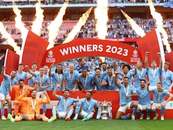 Manchester City players celebrate with the trophy after winning the FA Cup on June 3, 2023