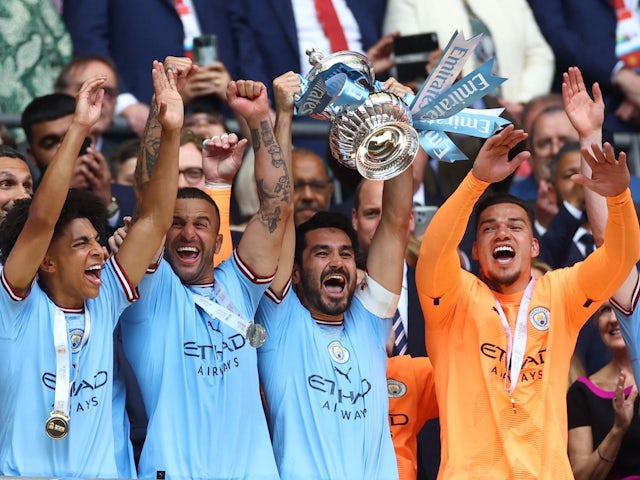 Manchester City's Ilkay Gundogan lifts the trophy as he celebrates with teammates after winning the FA Cup on June 3, 2023