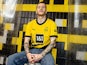 Marco Reus models the Dortmund 2023-24 home kit