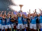 Napoli's Giovanni Di Lorenzo lifts the trophy as he celebrates with teammates after winning Serie A on June 4, 2023